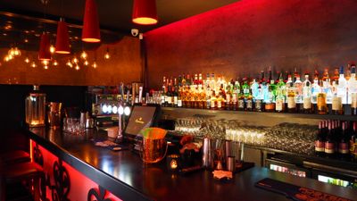 Inside The Copper Fox — warm brick and brass